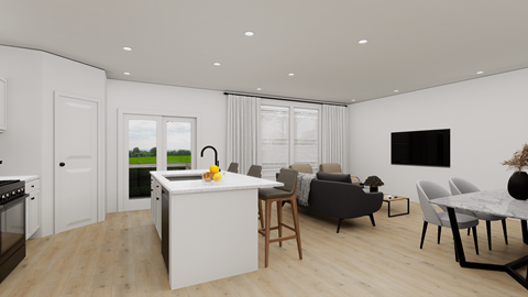 a kitchen and living room with white walls and wood flooring